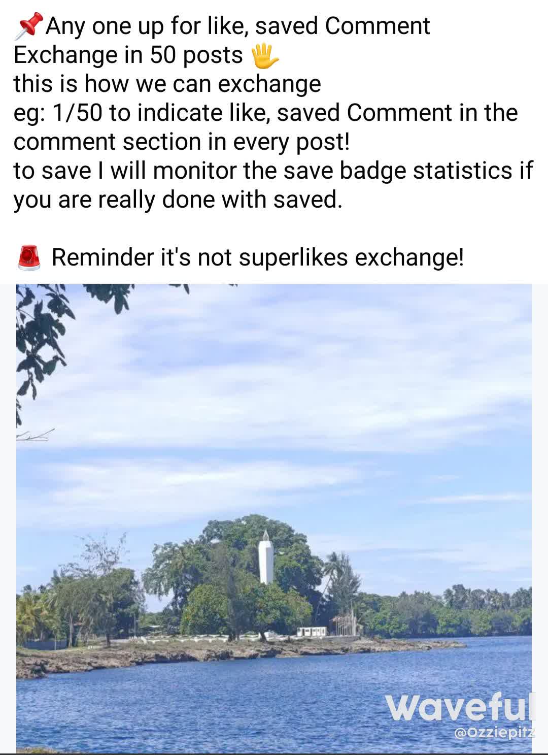 The image features a white lighthouse on a small island, surrounded by trees. The lighthouse is situated near a body of water, possibly a lake. The scene is set against a blue sky, creating a serene and picturesque atmosphere.
